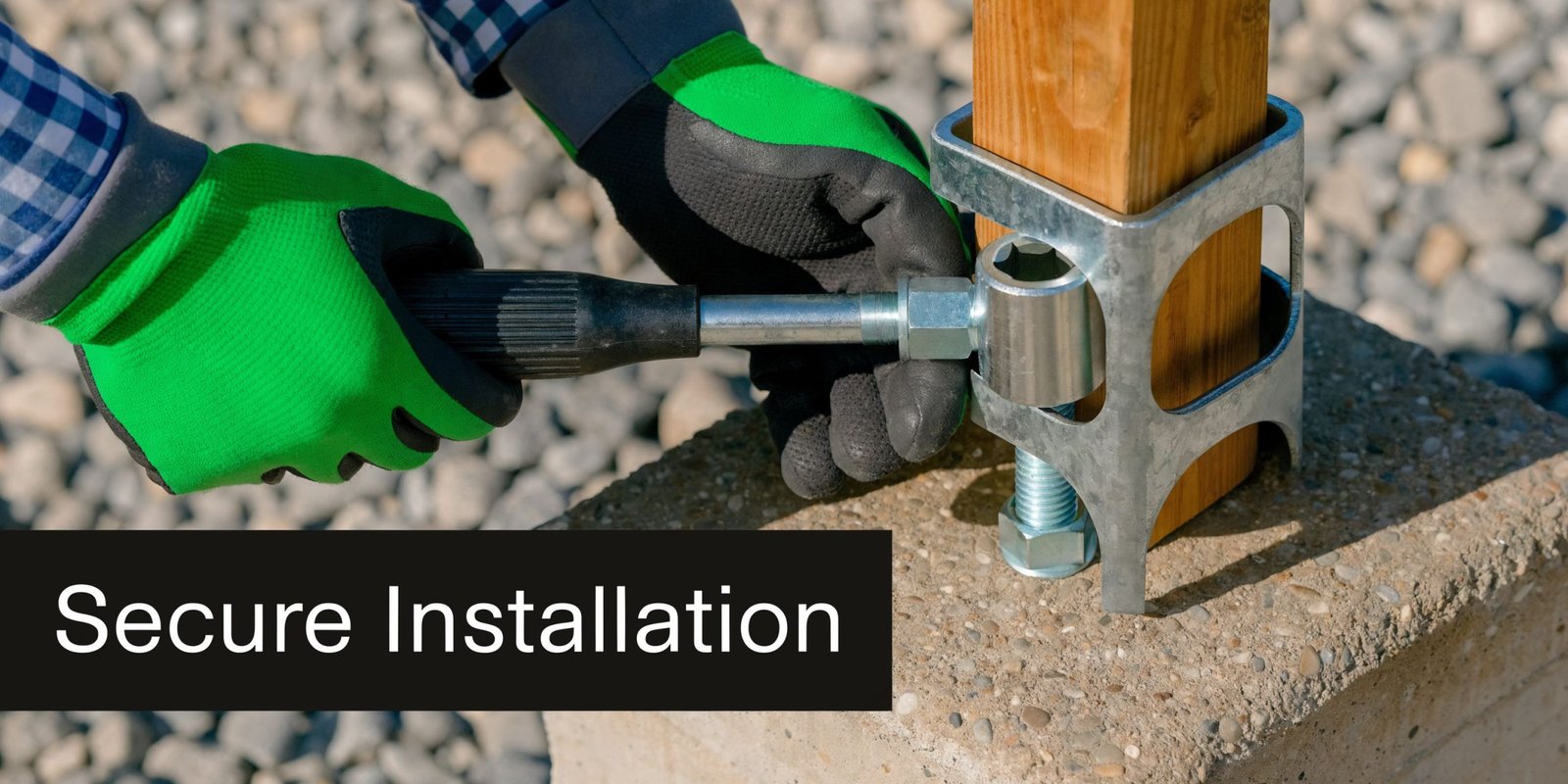 A construction worker securing a wooden deck post with a metal bracket and a hand tool.