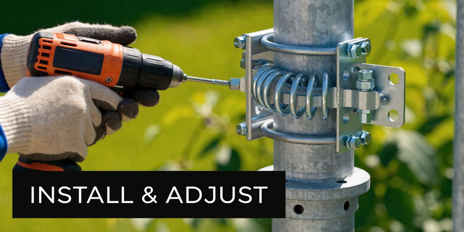 A gloved worker uses a power drill to adjust a metal self-closing spring hinge on a fence post.